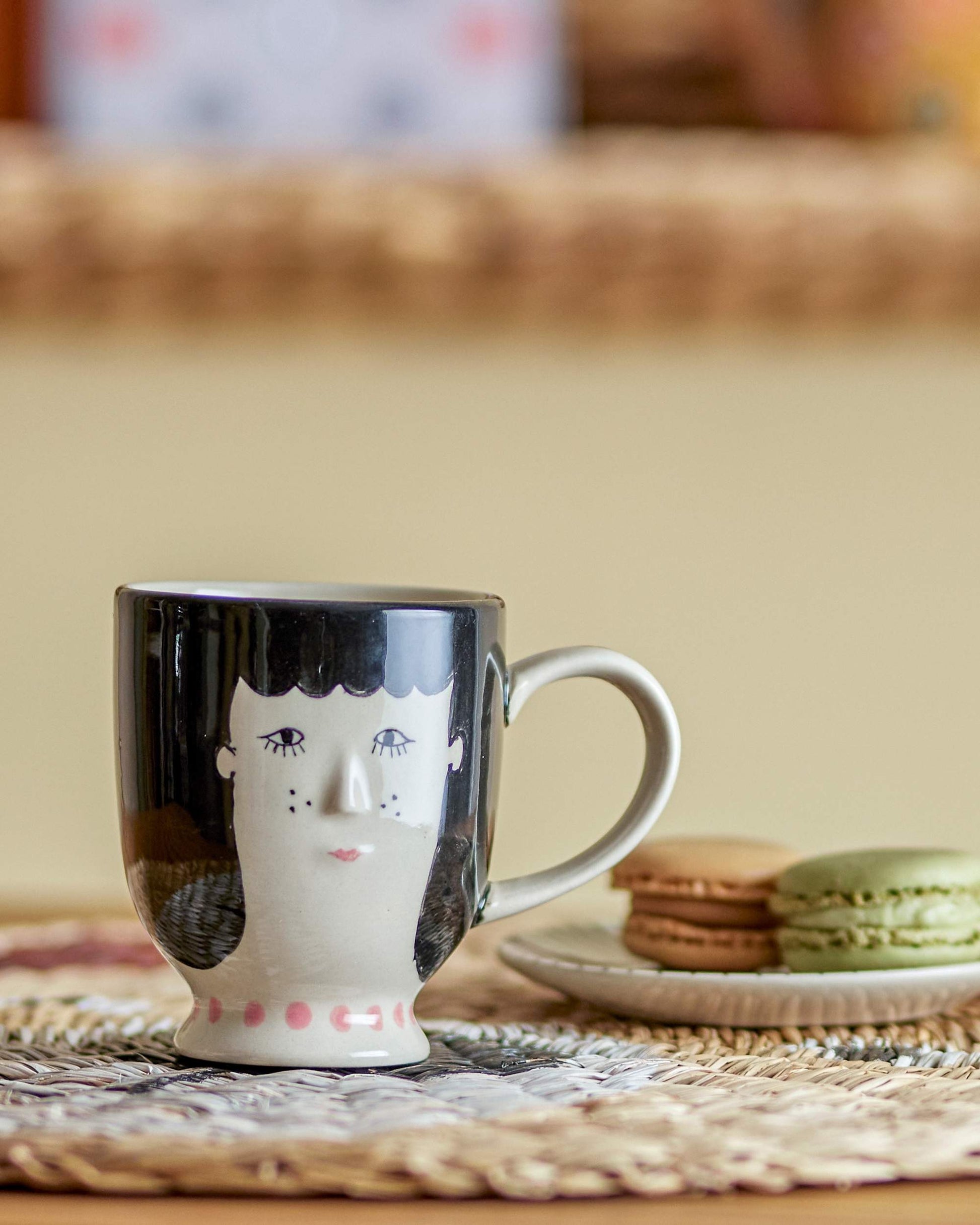 Keramiktasse mit Gesicht.